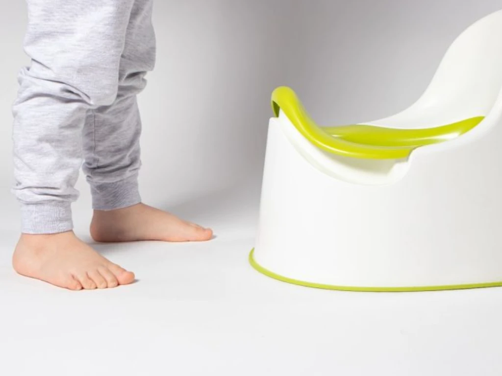 Child using a potty during toilet training for constipation management